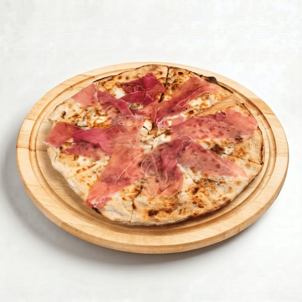 Sliced Italian flatbread topped with thinly sliced cured ham on a round wooden serving board.